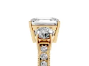 Emerald Cut Diamond Three-Stone Ring Set in Yellow gold with Round Side Stones and Pavé Band