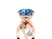 Fancy Blue Round Cut Diamond Solitaire Ring Set in Rose gold with Side Stones on Criss-Cross Band and Prong Setting