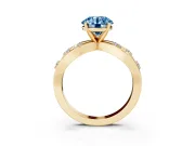 Fancy Blue Round Cut Diamond Solitaire Ring Set in Yellow gold with Side Stones on Criss-Cross Band and Prong Setting