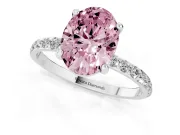 Fancy Pink Oval Cut Diamond Solitaire Ring Set in Platinum with Round Pavé Band and Prong Setting