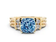 Fancy Blue Three-Stone Cushion Cut Diamond Channel Set Ring Set in Yellow gold with Bar Prongs