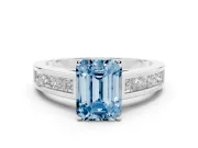 Fancy Blue Emerald Cut Diamond Solitaire Ring Set in Silver with Channel-Set Band and Prong Setting