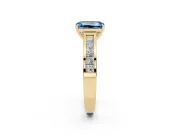 Fancy Blue Emerald Cut Diamond Solitaire Ring Set in Yellow gold with Channel-Set Band and Prong Setting