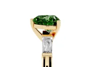 Fancy Green Heart Cut Diamond Solitaire Ring Set in Yellow gold with Tapered Baguette Side Stones and Prong Setting