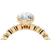 Marquise Cut Diamond Solitaire Engagement Ring Set in Yellow gold with Bezel Accents on Beaded Band