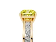 Fancy Yellow Cushion Cut Diamond Solitaire Ring Set in Yellow gold with Channel-Set Band and Prong Setting