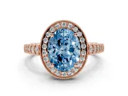 Fancy Blue Oval Cut Diamond Milgrain Halo Solitaire Ring Set in Rose gold with Bezel Set Side Stones and Pavé Band