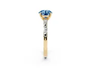 Fancy Blue Round Cut Diamond Solitaire Set in Yellow gold with Side Baguettes and Channel Set Band