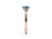 Fancy Blue Round Cut Diamond Solitaire Ring Set in Rose gold with Tapered Baguette Side Stones and Prong Setting