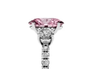 Fancy Pink Oval Cut Diamond Three-Stone Ring Set in Platinum with Pavé Band and Graduated Sides