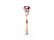Fancy Pink Three-Stone Princess Cut Diamond Ring Set in Rose gold with Pear Side Stones and Prong Setting