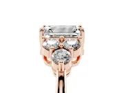 Emerald Cut Diamond Solitaire Ring Set in Rose gold with Cluster Accents on Each Side