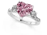 Fancy Pink Heart Cut Diamond Three-Stone Ring Set in Platinum with Pavé Band and Smaller Side Stones