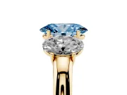 Fancy Blue Oval Cut Diamond Three-Stone Ring Set in Yellow gold with Bold Center and Classic Band