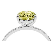 Fancy Yellow Oval Cut Diamond Solitaire Ring Set in Silver with Round Pavé Band and Prong Setting