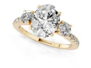 Oval Cut Diamond Three-Stone Ring Set in Yellow gold with Pavé Band and Graduated Sides