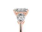 Three-Stone Emerald Cut Diamond Ring Set in Rose gold with Pear Side Stones and Prong Setting