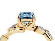 Fancy Blue Emerald Cut Diamond Solitaire Ring Set in Yellow gold with Twisted Marquise Accent Band