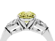 Fancy Yellow Three-Stone Oval Cut Diamond Ring Set in Platinum with Pear Side Stones and Prong Setting