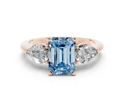 Fancy Blue Three-Stone Emerald Cut Diamond Ring Set in Rose gold with Pear Side Stones and Prong Setting