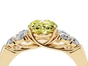 Fancy Yellow Oval Cut Diamond Cluster Ring Set in Yellow gold with Round Accent Stones and Prong Setting on a Plain Band
