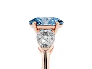 Fancy Blue Three-Stone Oval Cut Diamond Ring Set in Rose gold with Pear Side Stones and Prong Setting
