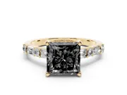 Fancy Black Princess Cut Diamond Solitaire Set in Yellow gold with Side Baguettes and Channel Set Band