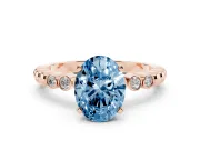 Fancy Blue Oval Cut Diamond Solitaire Engagement Ring Set in Rose gold with Bezel Accents on Beaded Band