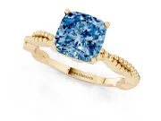 Fancy Blue Cushion Cut Diamond Solitaire Ring Set in Yellow gold with Twisted Band and Bead Prong Setting