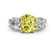 Fancy Yellow Oval Cut Diamond Three-Stone Ring Set in Yellow gold with Prong Setting and Classic Band