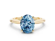 Fancy Blue Oval Cut Diamond Solitaire Ring Set in Yellow gold with Prong Setting on a Plain Round Band