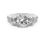 Cushion Cut Diamond Three-Stone Ring Set in White gold with Round Side Stones and Delicate Pavé Band