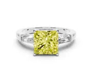 Fancy Yellow Princess Cut Diamond Solitaire Ring Set in White gold with Tapered Baguette Side Stones and Prong Setting