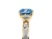 Fancy Blue Cushion Cut Diamond Solitaire Ring Set in Yellow gold with Channel-Set Baguette Band and Prong Setting