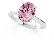 Fancy Pink Oval Cut Diamond Solitaire Ring Set in Silver with Prong Setting on a Plain Round Band