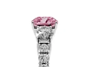 Fancy Pink Cushion Cut Diamond Three-Stone Ring Set in Platinum with Round Side Stones and Delicate Pavé Band