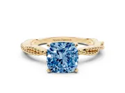 Fancy Blue Cushion Cut Diamond Solitaire Ring Set in Yellow gold with Twisted Band and Bead Prong Setting