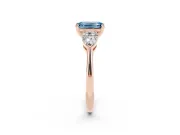 Fancy Blue Three-Stone Emerald Cut Diamond Ring Set in Rose gold with Pear Side Stones and Prong Setting