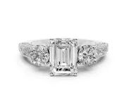Emerald Cut Diamond Three-Stone Ring Set in Platinum with Round Side Stones and Pavé Band