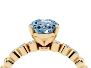 Fancy Blue Oval Cut Diamond Solitaire Engagement Ring Set in Yellow gold with Bezel Accents on Beaded Band