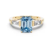 Fancy Blue Emerald Cut Diamond Solitaire Ring Set in Yellow gold with Tapered Baguette Side Stones and Prong Setting