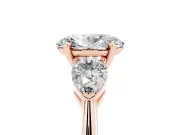 Three-Stone Oval Cut Diamond Ring Set in Rose gold with Pear Side Stones and Prong Setting