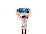 Fancy Blue Heart Cut Diamond Solitaire Ring Set in Rose gold with Tapered Baguette Side Stones and Prong Setting