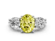 Fancy Yellow Oval Cut Diamond Three-Stone Ring Set in White gold with Prong Setting and Classic Band