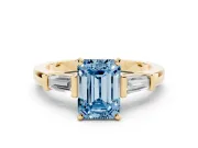 Fancy Blue Emerald Cut Diamond Solitaire Ring Set in Yellow gold with Tapered Baguette Accents and Prong Setting