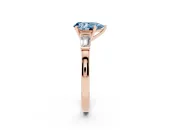 Fancy Blue Pear Cut Diamond Solitaire Ring Set in Rose gold with Tapered Baguette Accents and Prong Setting