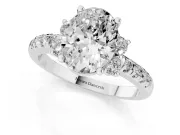 Oval Cut Diamond Three-Stone Pavé Ring Set in Platinum with Prong Setting