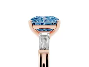 Fancy Blue Radiant Cut Diamond Solitaire Ring Set in Rose gold with Tapered Baguette Side Stones and Prong Setting