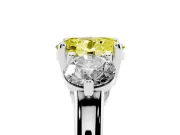 Fancy Yellow Oval Cut Diamond Three-Stone Ring Set in Platinum with Prong Setting and Classic Band