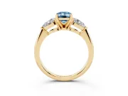 Fancy Blue Three-Stone Emerald Cut Diamond Ring Set in Yellow gold with Pear Side Stones and Prong Setting